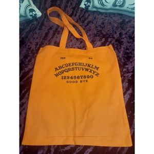 Black and orange Ouija board tote bag